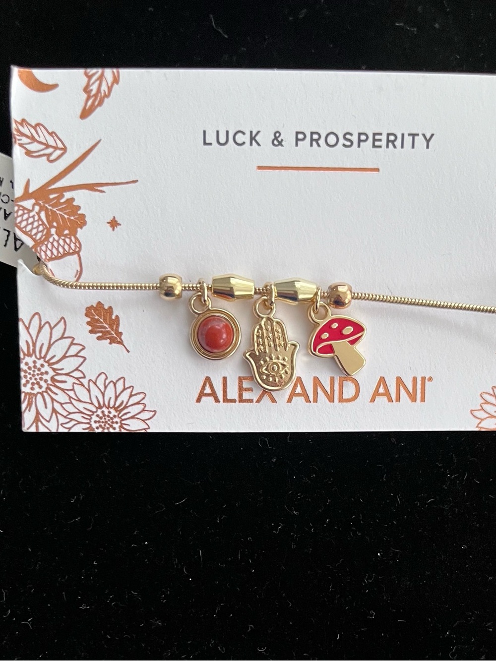 Alex and Ani Gold-Tone Bracelet with Red Enamel Mushroom and Hamsa Charms